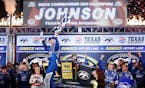 Sprint Cup driver Jimmie Johnson celebrates winning the Duck Commander 500 at Texas Motor Speedway in Fort Worth, Texas, on Saturday, April 11, 2015. 