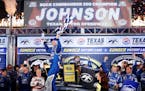 Sprint Cup driver Jimmie Johnson celebrates winning the Duck Commander 500 at Texas Motor Speedway in Fort Worth, Texas, on Saturday, April 11, 2015. 