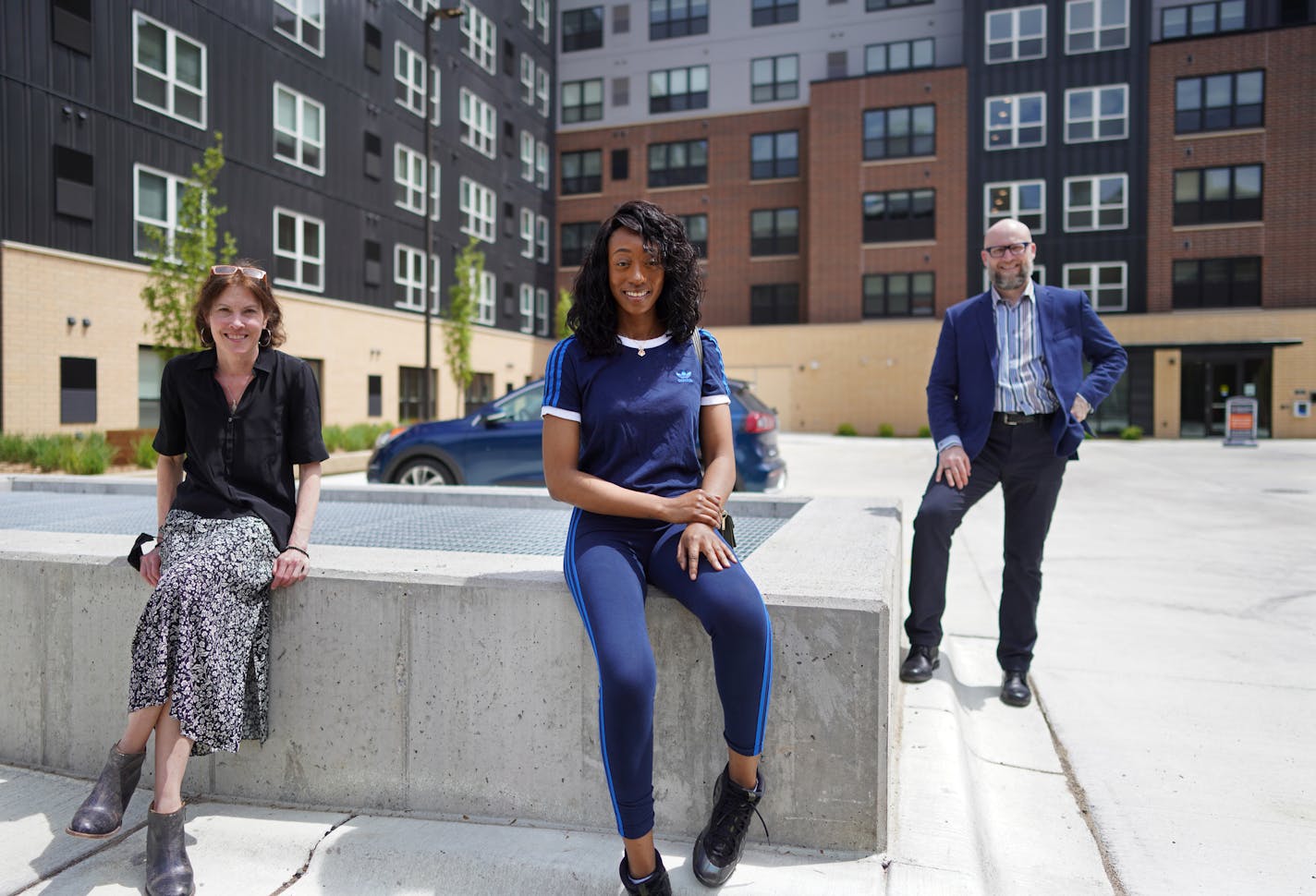 Elizabeth Flannery of Community Housing Development Corp., Rheasa Otto and the Rev. Dan Collison, outside East Town Apartments in downtown Minneapolis.