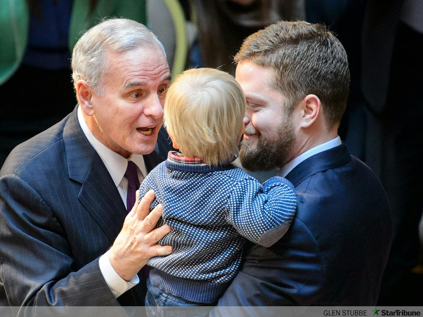 Governor Mark Dayton is sworn in greeted grandson Hugo held by Dayton's son Eric.       ]   GLEN STUBBE * gstubbe@startribune.com   Monday January 5,  2015   Next Monday, January 5, Governor Mark Dayton and Lt. Governor-Elect Tina Smith will take the oath of office at an official inauguration ceremony beginning at 12:00pm at the Landmark Center in St. Paul.  138026