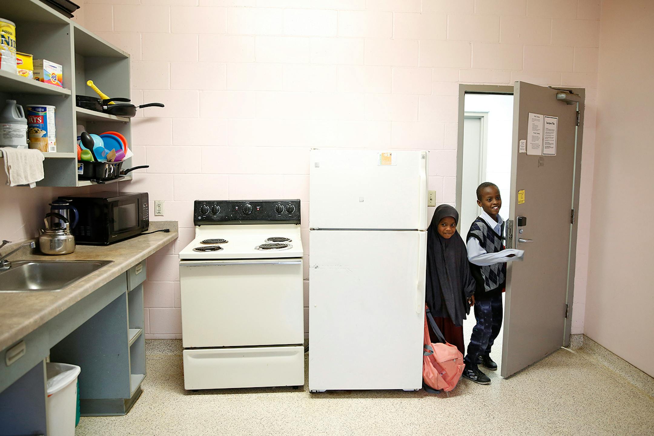 Recent Somali immigrants Ugbad Shukri, left, 7, and her brother Antar Shukri, 10, arrive home to Mary's Place transitional apartments in downtown Minneapolis from school in the afternoon. ] LEILA NAVIDI leila.navidi@startribune.com / BACKGROUND INFORMATION: Tuesday, October 28, 2014. Minnesota has seen a marked uptick in new Somali refugee arrivals recently. The number of Somalis arriving directly from Africa has more than tripled in four years. But community leaders say there's also been an inc