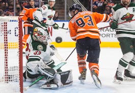 Minnesota Wild goalie Cam Talbot (33) makes a save on Edmonton Oilers’ Ryan Nugent-Hopkins (93) during the second period.