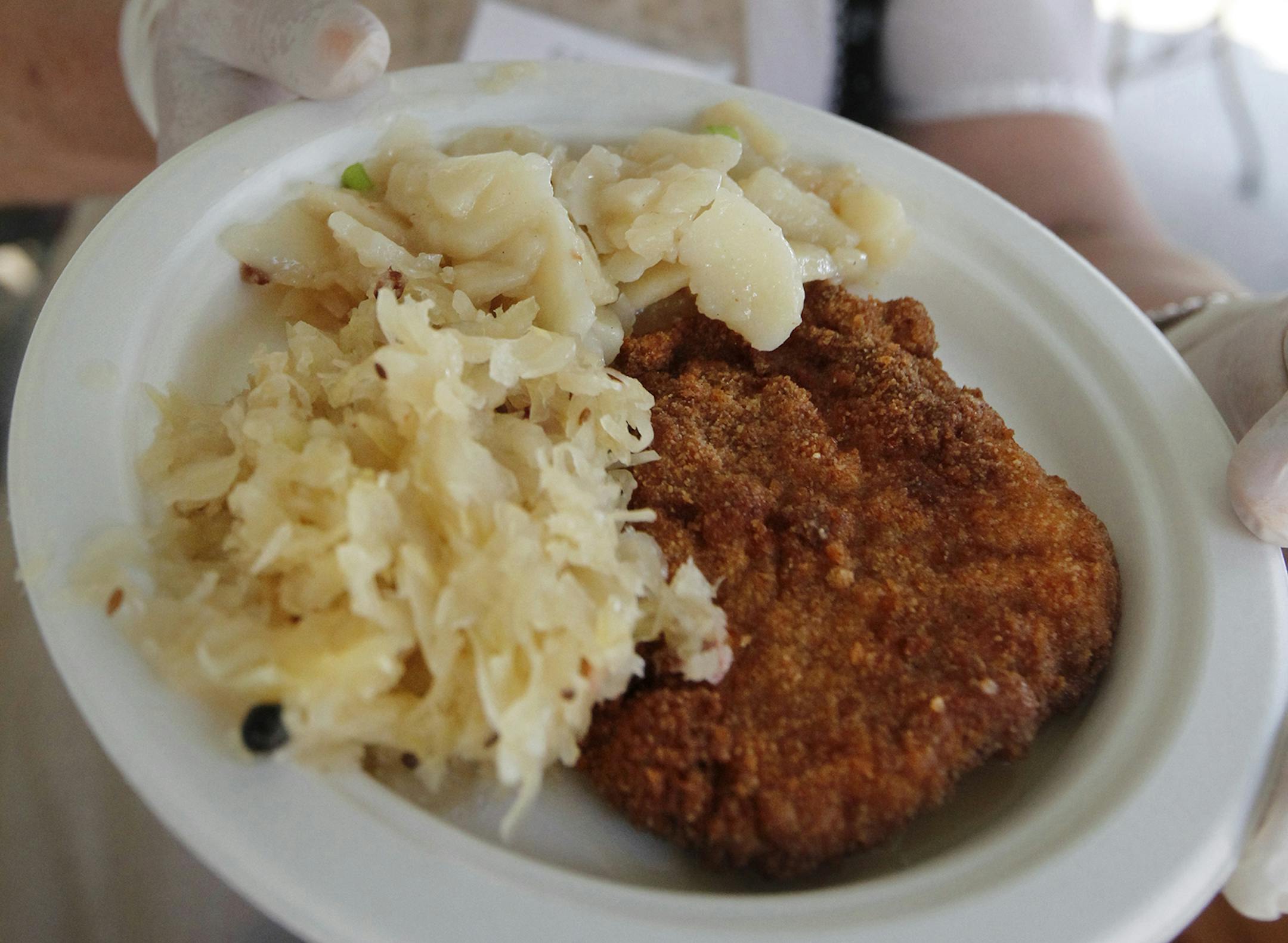 At the festival at the Germanic-American Institute in St. Paul, schnitzel, potato salad, and sauerkraut is served. rtsong-taatarii@startribune.com ORG XMIT: MIN2013052815160529