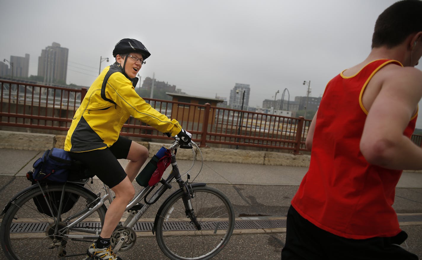 On the way home on the Stone Arch Bridge, Pam Nelms commutes 75 miles a week to work rain, snow, sleet, or sun year round. ] richard tsong-taatarii@startribune.com