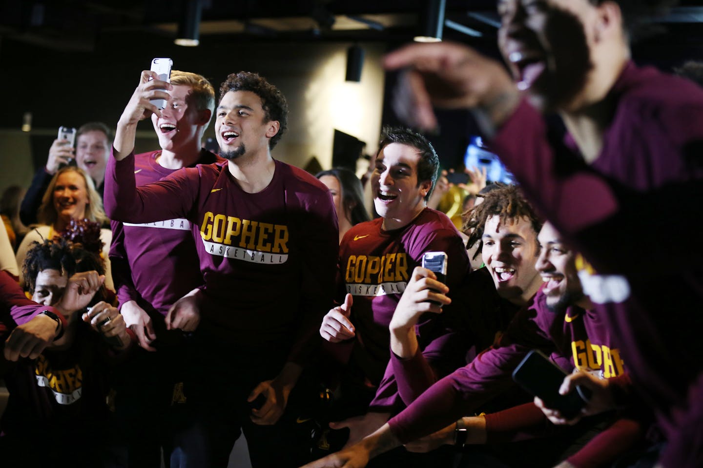 Gophers players (from left) Brady Rudrud, Stephon Sharpe, Darin Haugh and Reggie Lynch celebrated with teammates after Minnesota found out its first-round matchup in the NCAA college basketball tournament on Selection Sunday.