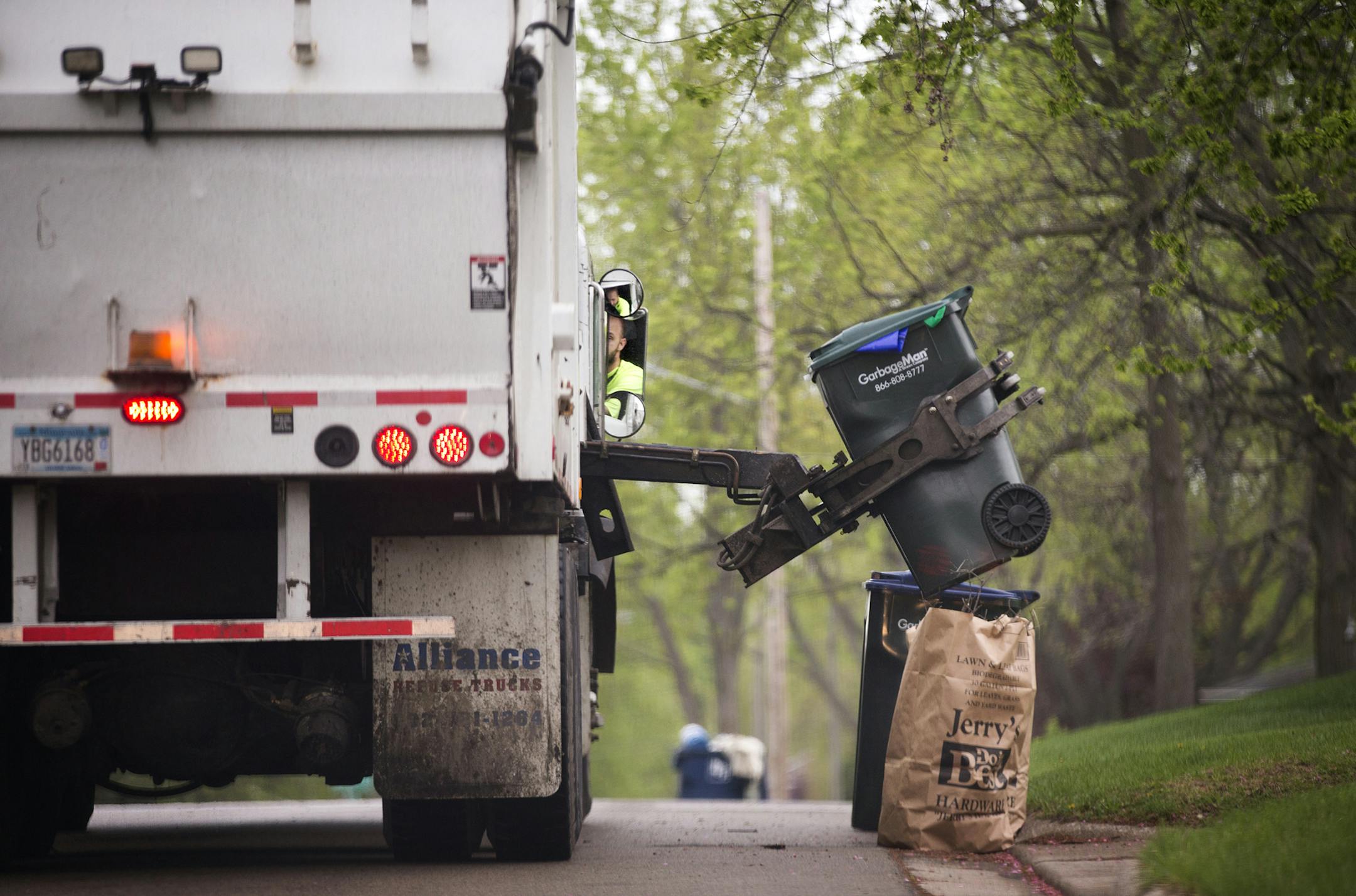 A GarbageMan worker empties containers onto the truck on trash pickup day in Bloomington between France Avenue and Normandale Boulevard on Thursday, May 7, 2015. ] LEILA NAVIDI leila.navidi@startribune.com / ORG XMIT: MIN1505071102290886 ORG XMIT: MIN1602051208504688