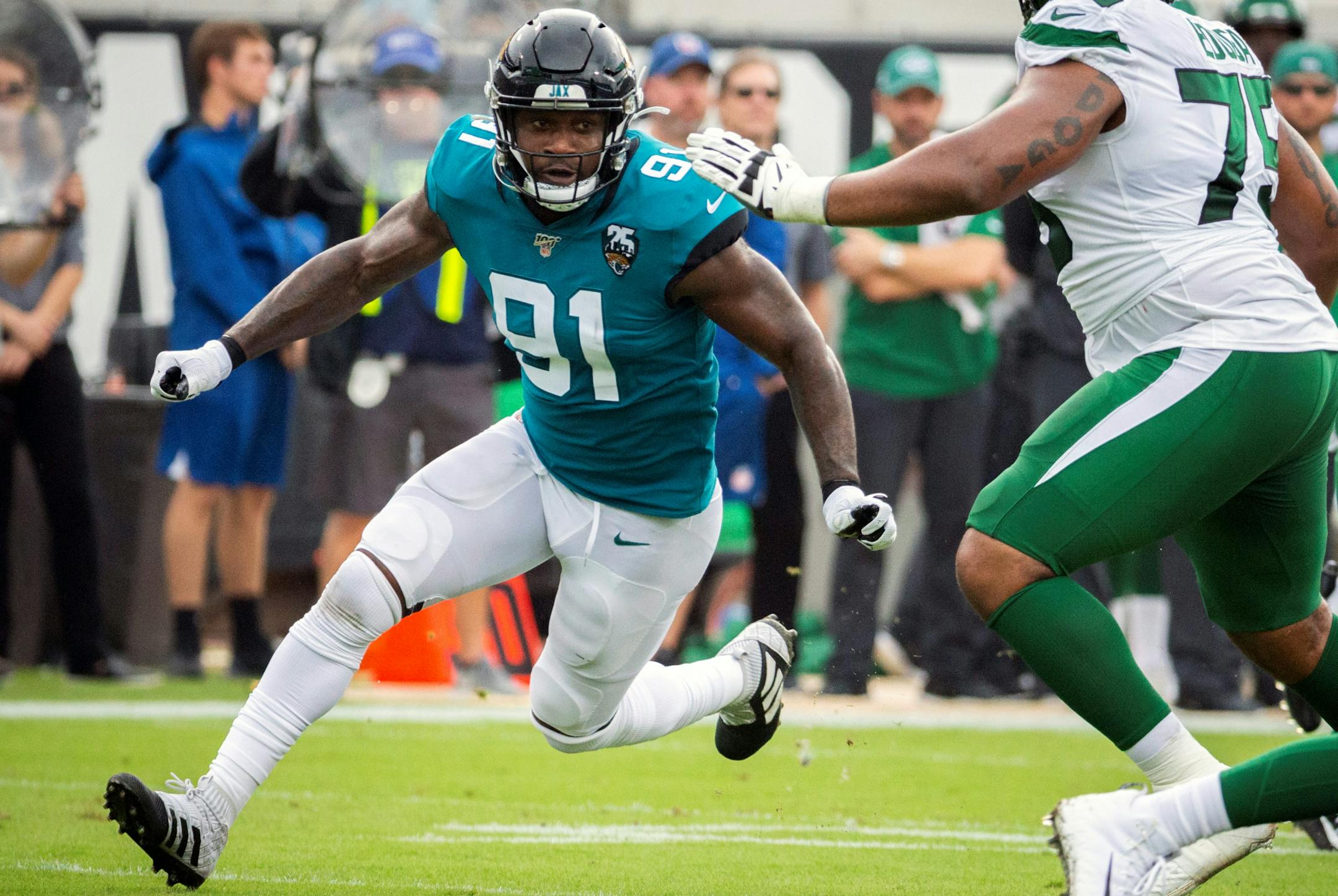 FILE - In this Oct. 27, 2019, file photo, Jacksonville Jaguars defensive end Yannick Ngakoue (91) rushes New York Jets quarterback Sam Darnold (14) during the first half of an NFL football game, in Jacksonville, Fla. When or if Yannick Ngakoue returns to the Jacksonville Jaguars, the disgruntled defensive end will need several introductions. The Jaguars have been forced to revamp their defensive line during the first two weeks of training camp, and they don't appear done. (AP Photo/Stephen B. Morton, File)