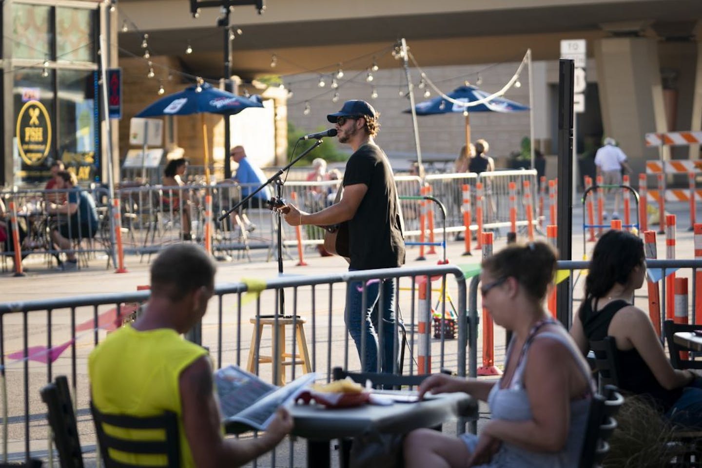 Musician Matt Browne performed on a closed down street in downtown Hastings, Minn., on Friday, July 24, 2020. The road closes on weekends to allow pedestrians and several restaurants with patios be able to spread out and not worry about cars. Browne was hired by Spiral Brewery but was playing for the whole street.