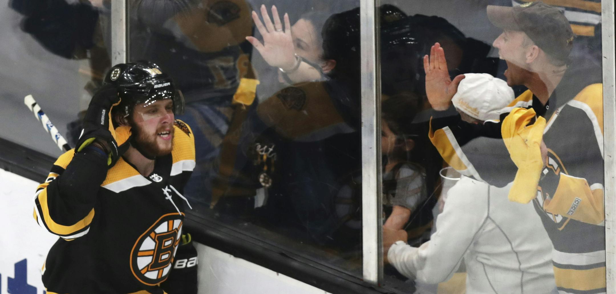 Boston Bruins right wing David Pastrnak (88) celebrates with fans after his goal off Columbus Blue Jackets goaltender Sergei Bobrovsky (not shown) during the third period of Game 5 of an NHL hockey second-round playoff series, Saturday, May 4, 2019, in Boston. (AP Photo/Charles Krupa)