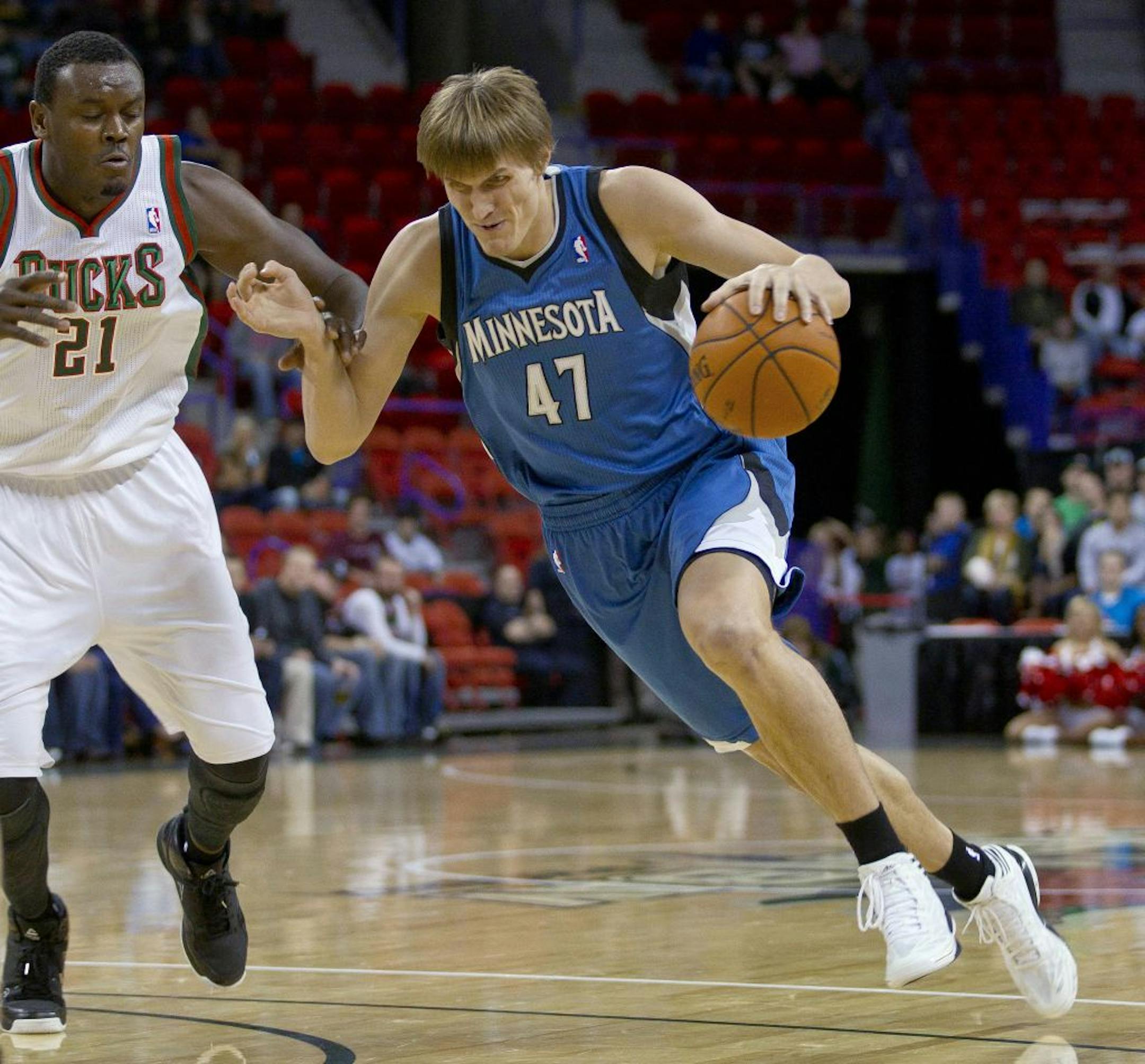 Minnesota Timberwolves forward Andrei Kirilenko tries to drive past Milwaukee Bucks center Samuel Dalembert during the first half of an NBA preseason basketball game Friday, Oct. 26, 2012, in Green Bay, Wis. Minnesota won 100-76.