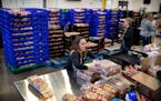 Staff and volunteers at Second Harvest Heartland, the state's largest food bank, filled emergency food kits in response to the coronavirus at its ware