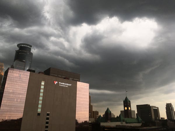 Dark clouds rolled into the Twin Cities early Thursday evening, bringing rain, thunder and lightning to much of the area, including downtown Minneapol