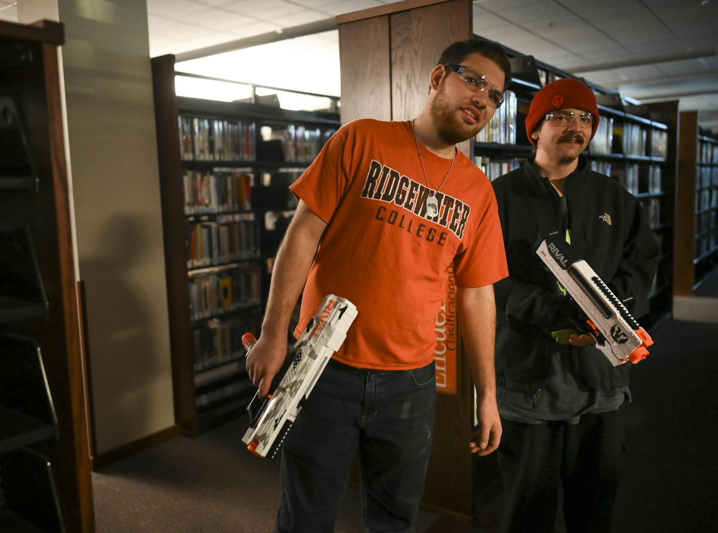 From left, Nick Vanderkooi, 20, a student at Ridgewater College, and David Hernandez, 19, a McDonald's employee, teamed up to take part in Friday night's "Humans vs. Zombies" Nerf gun battle at the Willmar Public Library.