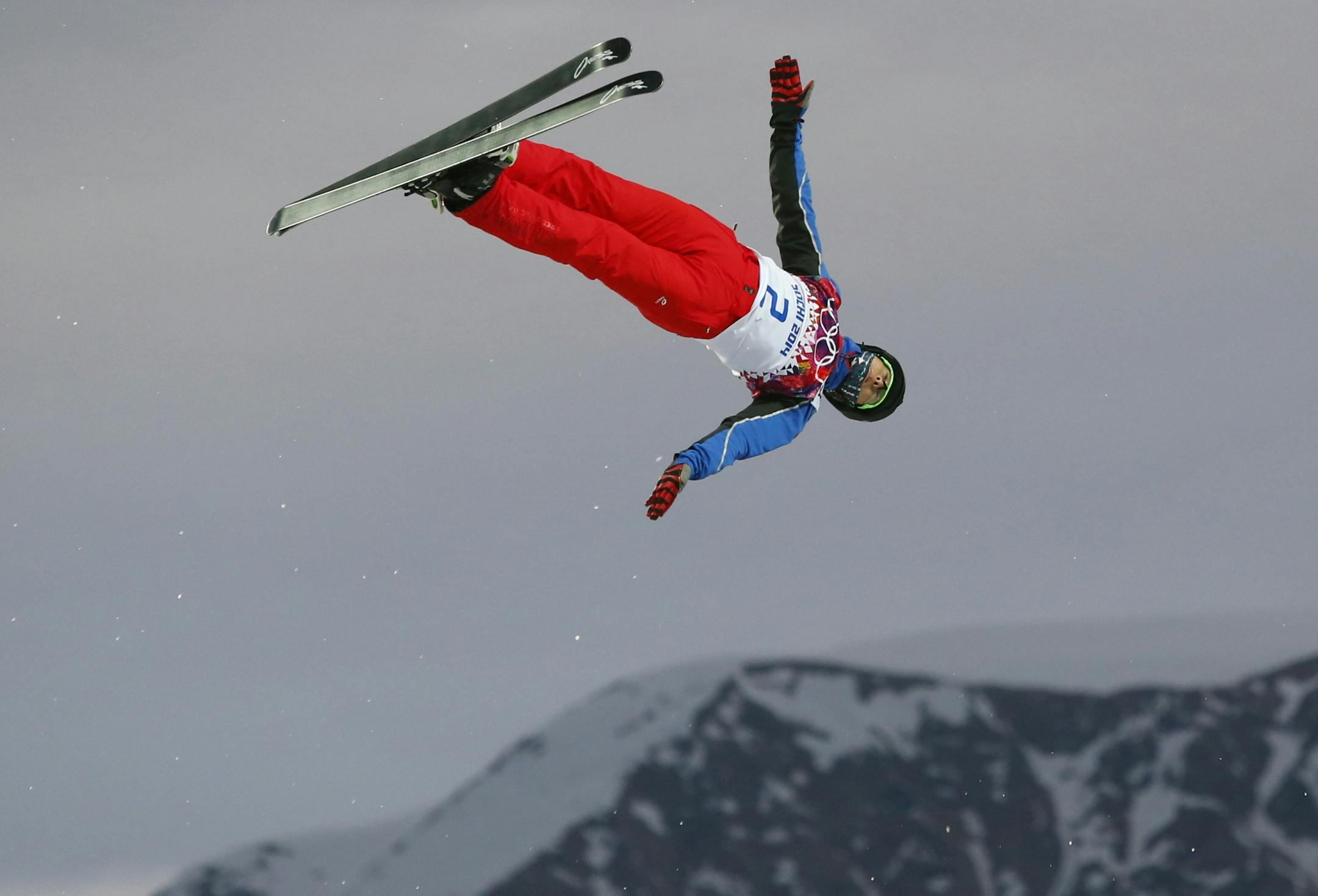 China's Qi Guangpu jumps during men's freestyle skiing aerials qualifying at the Rosa Khutor Extreme Park, at the 2014 Winter Olympics, Monday, Feb. 17, 2014, in Krasnaya Polyana, Russia.