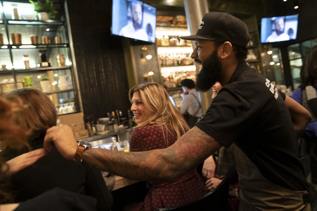 ‘Top Chef’ contestant Justin Sutherland laughed with guests of his restaurant the Handsome Hog in St. Paul, Minn., as they watched ‘Top Chef’ on television.