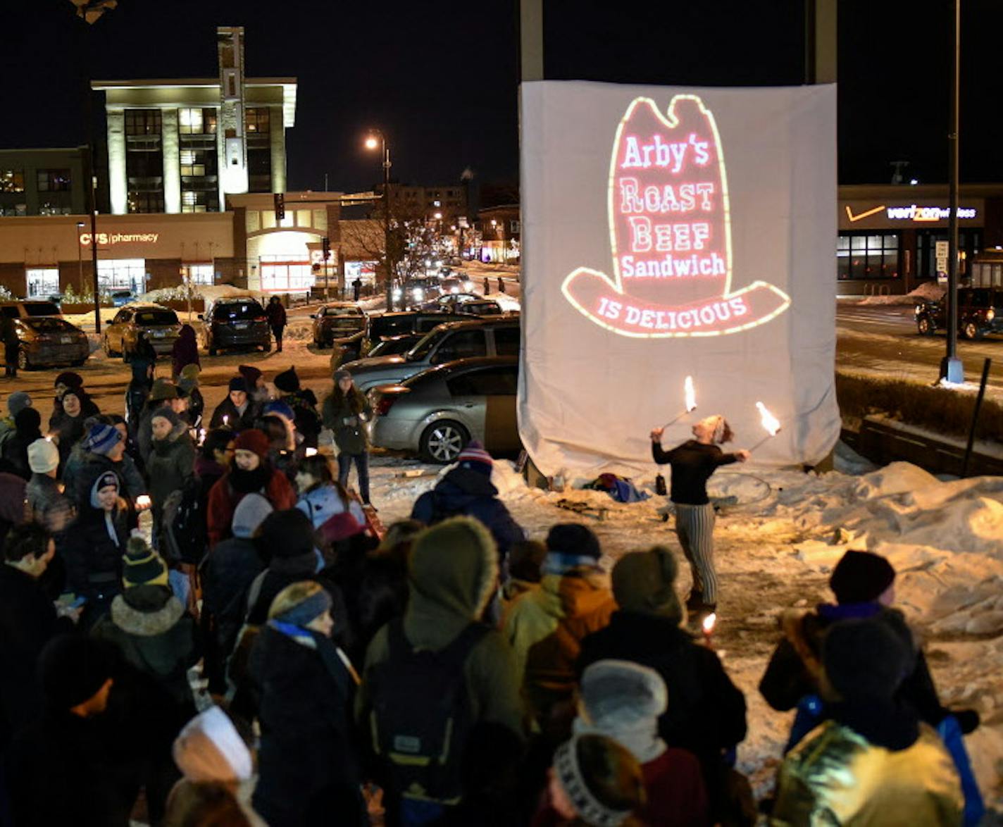 Chloe Bosak , of Andover, fire danced in front of a projected Arby's logo that was put in place of the recently-removed sign as dozens of vigil goers mourned the loss of the Uptown Arby's Friday night.. ] AARON LAVINSKY &#xef; aaron.lavinsky@startribune.com Minnesotans mourned the loss of the Uptown Arby's sign with a candlelight vigil after the fast-food restaurant went out of business after being open for 47 years. The vigil was photographed Friday, Feb. 9, 2018 in Minneapolis, Minn.