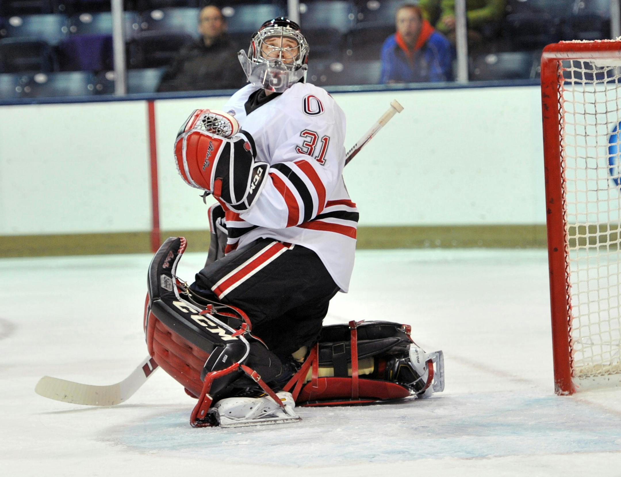 Nebraska at Omaha goalie Ryan Massa (31) looks over his head for a puck in first period of a regional final in the NCAA college hockey tournament Sunday, March 29, 2015 in South Bend, Ind. (AP Photo/Joe Raymond)