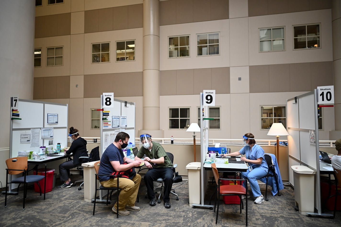 Mike Babcock, 38, of St. Paul, spoke to nurse Matt Brenner after receiving a dose of the Pfizer-BioNTech COVID-19 vaccine Tuesday. Babcock said he got a text from the VA letting him know he was now eligible to receive the vaccine. ] AARON LAVINSKY • aaron.lavinsky@startribune.com