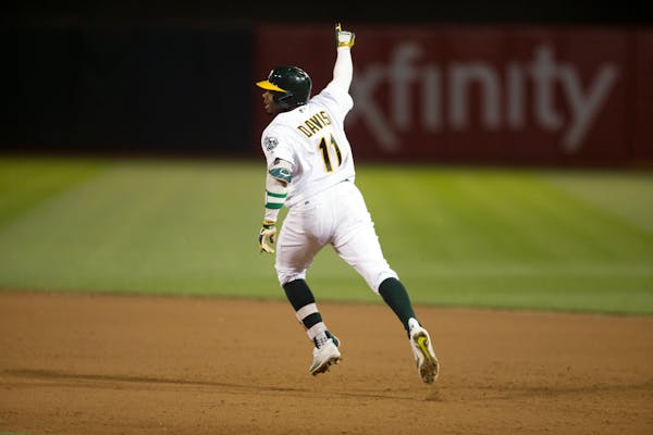 Oakland Athletics' Rajai Davis gestures as he rounds the bases after hitting the game-winning two-run home run against the Minnesota Twins during the 