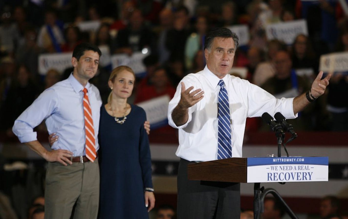 Republican presidential candidate Mitt Romney Paul Ryan and his wife Janna listen at a campaign rally at the Marion County Fairgrounds in Marion, Ohio on Sunday, Oct. 28, 2012. The storm on the East Coast caused Mitt Romney to join Paul Ryan at the campaign stop in Ohio.