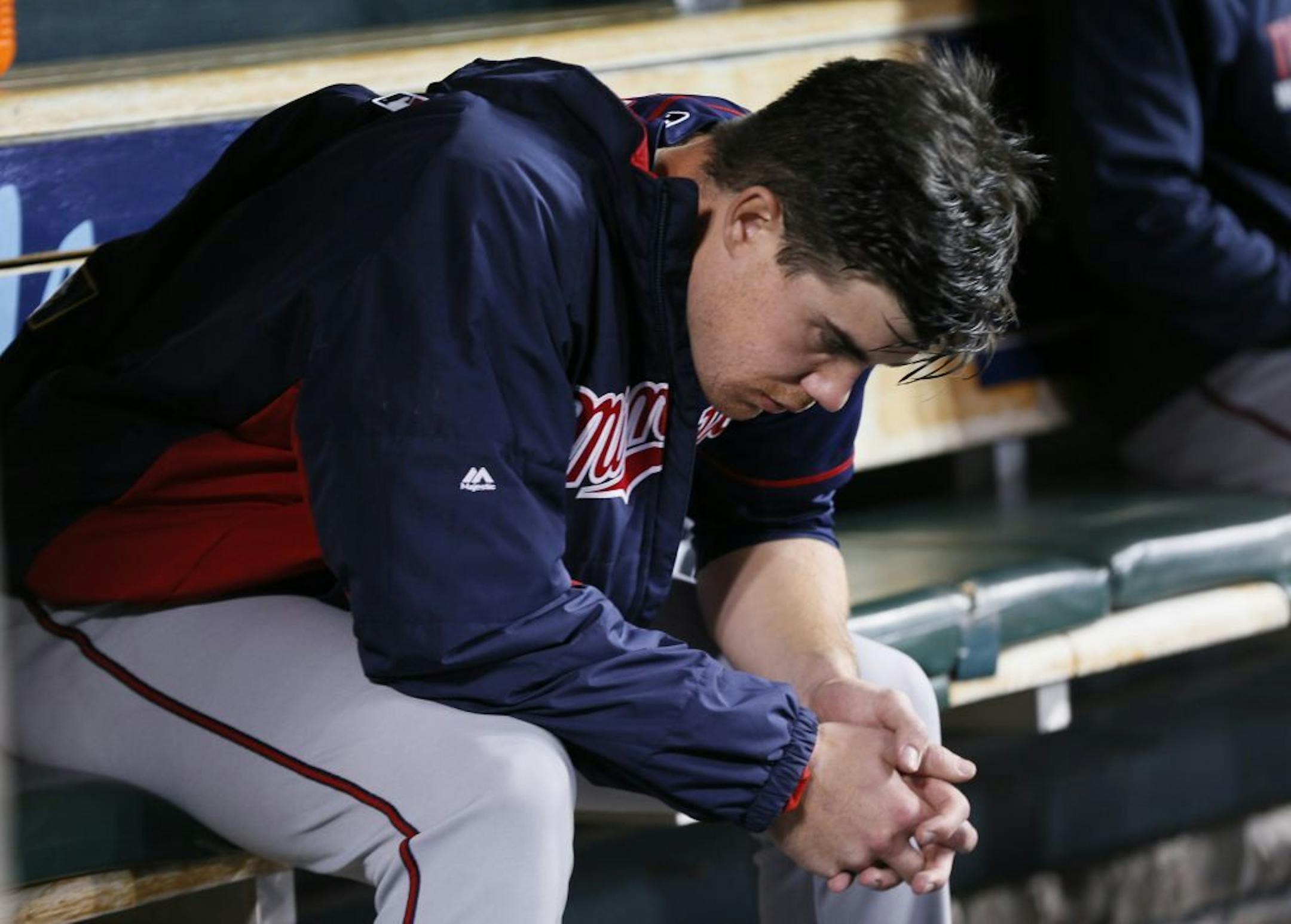 Minnesota Twins starting pitcher Trevor May sits on the bench in the the fifth inning of a baseball game against the Detroit Tigers in Detroit Thursday, Sept. 25, 2014.