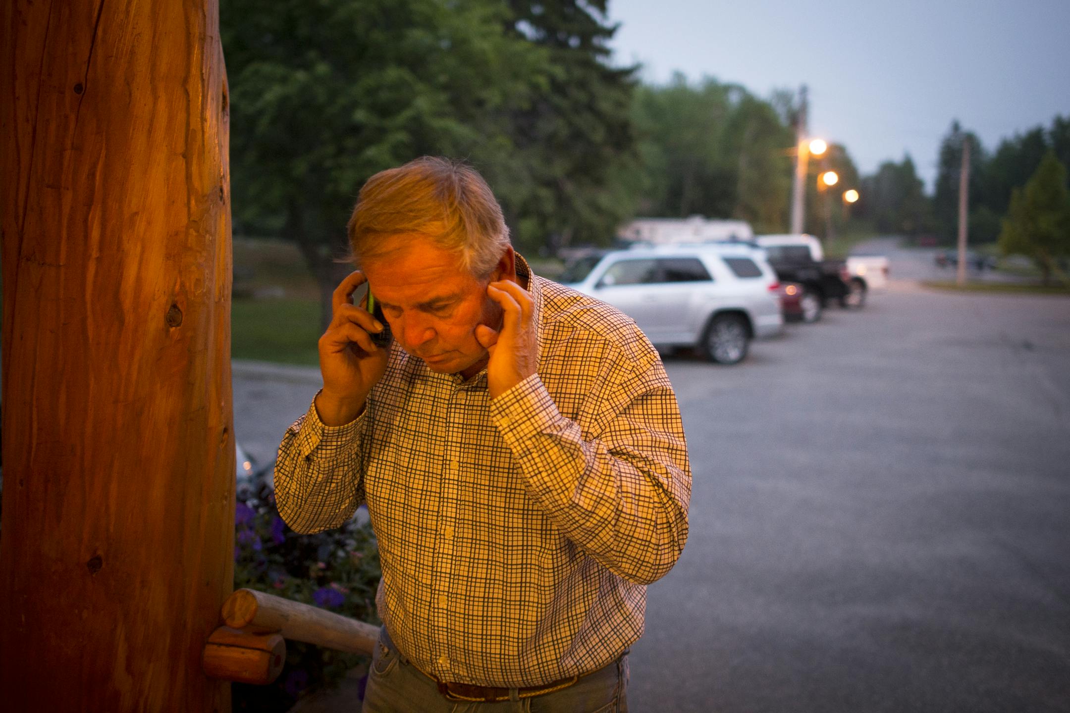 Rainer Mayor and businessman Dennis Wagner took a work call outside the Thunderbird Lodge on Ranier Lake in early June. ] Aaron Lavinsky • aaron.lavinsky@startribune.com Story on Ranier Mayor and businessman Dennis Wagner.
