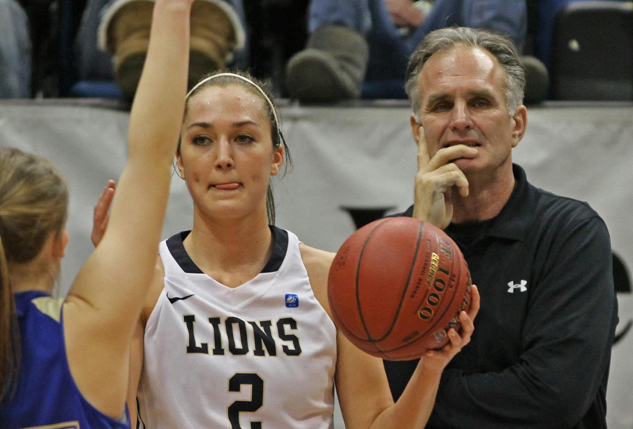 Providence Academy's Taylor Finley got ready to throw the ball as head coach Ray Finley watched