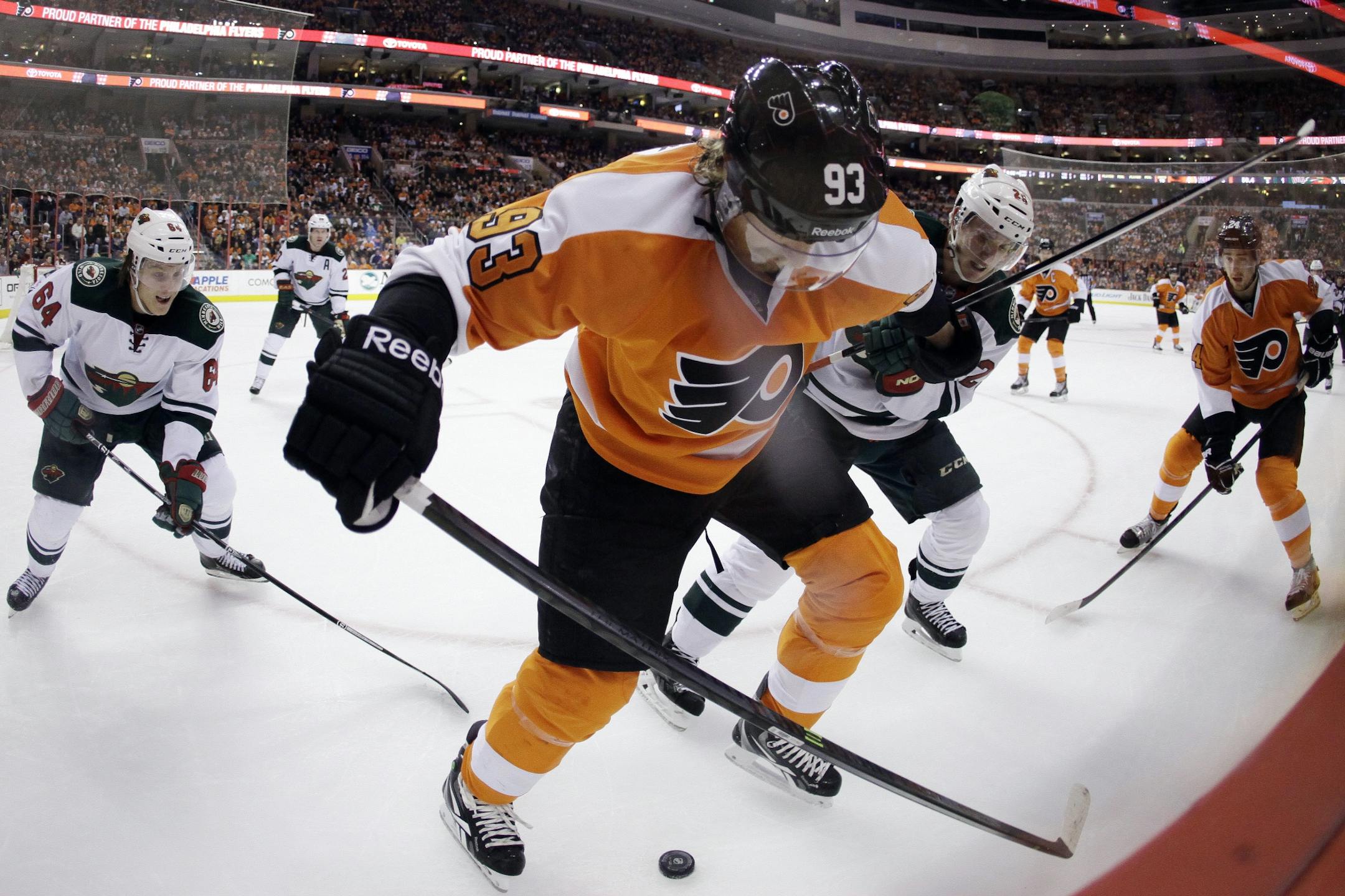 Philadelphia Flyers' Jakub Voracek (93), of the Czech Republic, battles for the puck against Minnesota Wild's Jonas Brodin (25), of Sweden, during the third period of an NHL hockey game, Monday, Dec. 23, 2013, in Philadelphia.