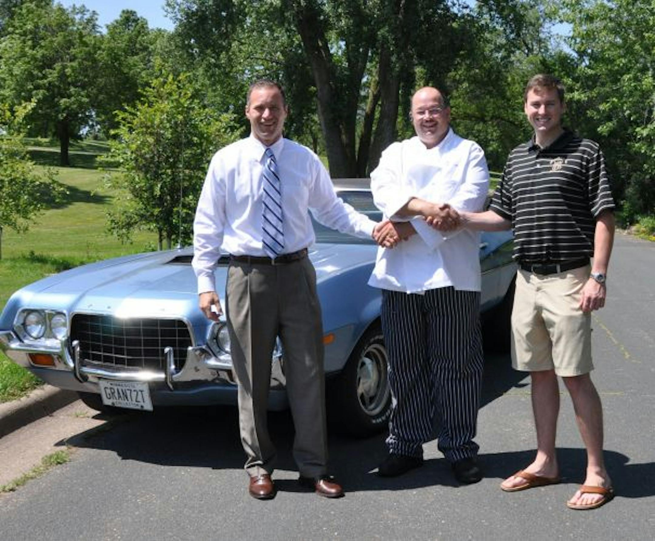 Jerry Kane, center, got the 1972 Gran Torino behind him by offering to cater a wedding for 250 guests. With him are the Big Trade Up's Tony DelDotto, in tie, and Chad Commers, at right.