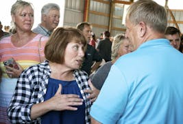 Minnesota gubernatorial candidate Erin Murphy talks with voters at the end of a forum ahead of next week's primary, at the annual FarmFest in Redwood 