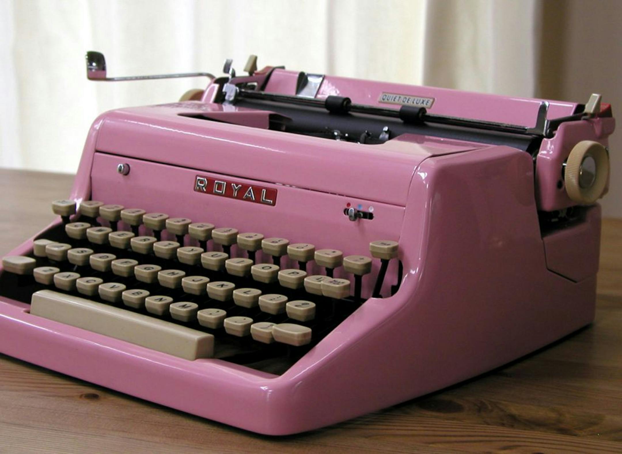 A 1950s manual typewriter in Pepto pink