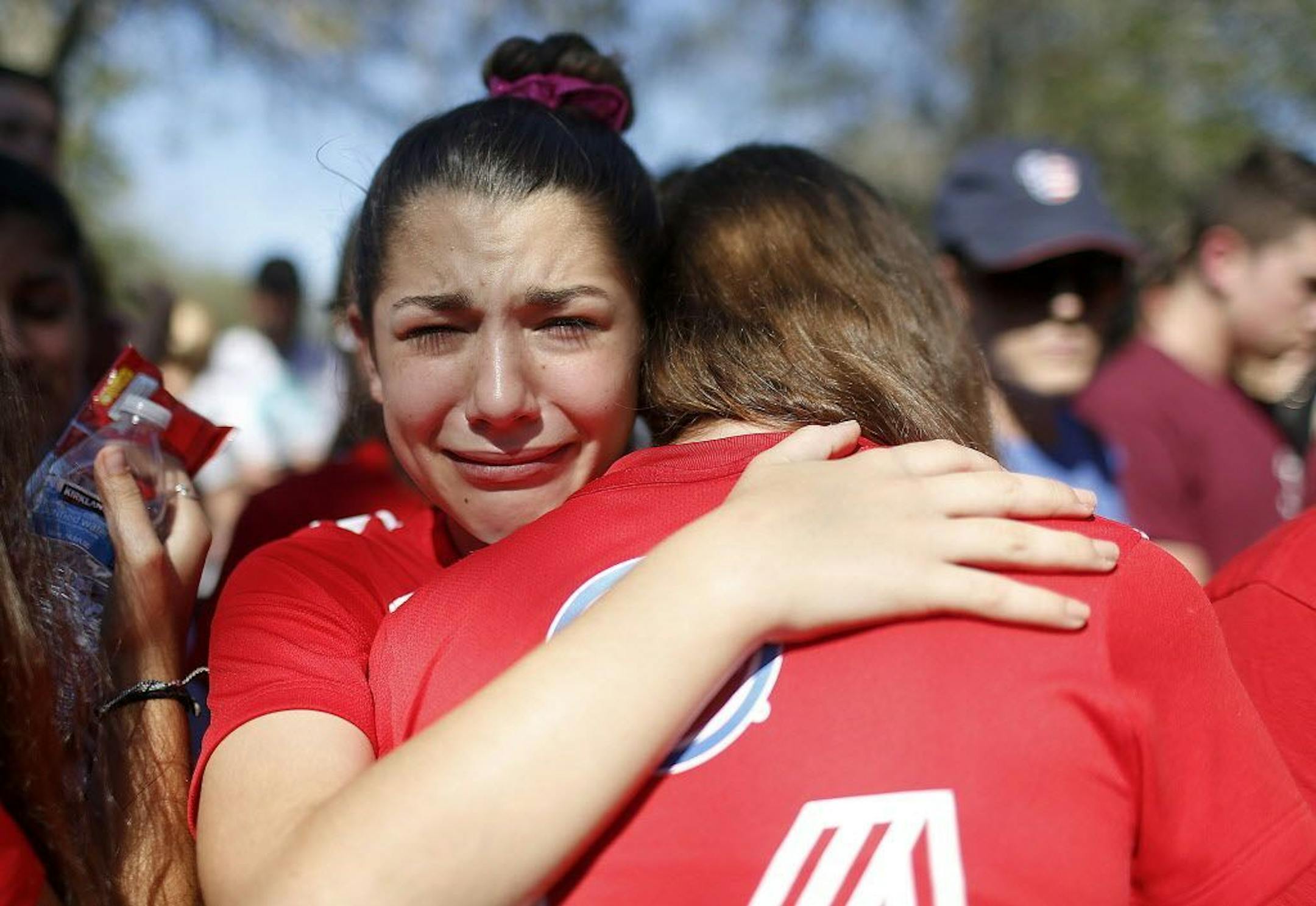 A student mourns the loss of her friend during a community vigil at Pine Trails Park, Thursday, Feb. 15, 2018, in Parkland, Fla., for the victims of the shooting at Marjory Stoneman Douglas High School. Nikolas Cruz, a former student, was charged with 17 counts of premeditated murder on Thursday.