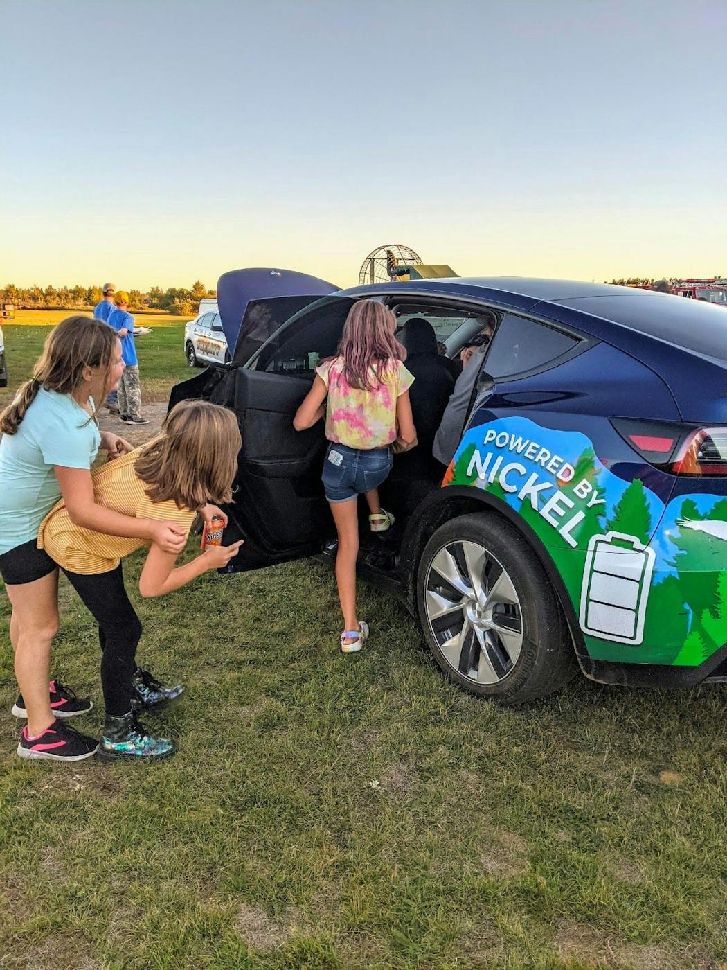Children played near a battery-powered Tesla vehicle at a summer festival near Tamarack, Mn., and the proposed site of the Talon Metals nickel mine in northern Minnesota.