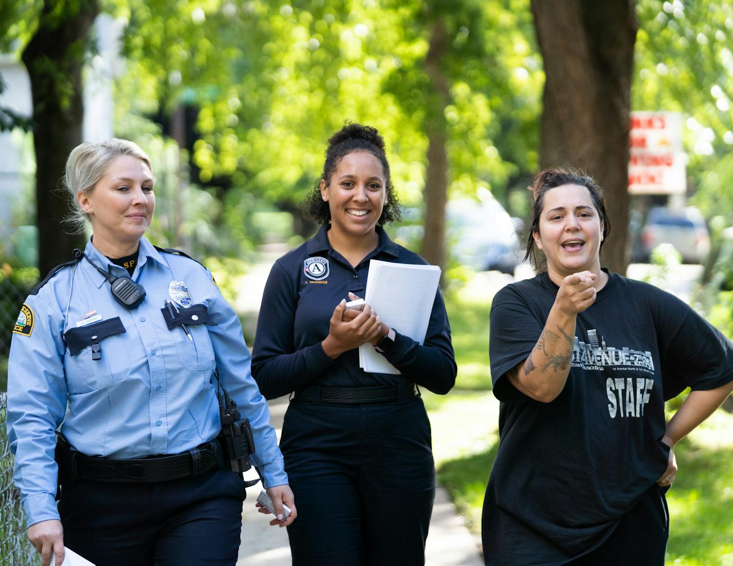 Reserve officer Carly Oszman and Law Enforcement Career Path Academy member Tanisha Morgan listen to resident Nancy Larrabee talk about the neighborhood. Larrabee lives on the block with her husband and fifteen month old daughter. ] MARK VANCLEAVE &#xa5; Reservists with the St. Paul Police Department canvassed blocks near Rice St. and Winnipeg Ave. W on Friday, Sep. 13, 2019 in St. Paul. The neighborhood was the scene of a recent gun homicide.