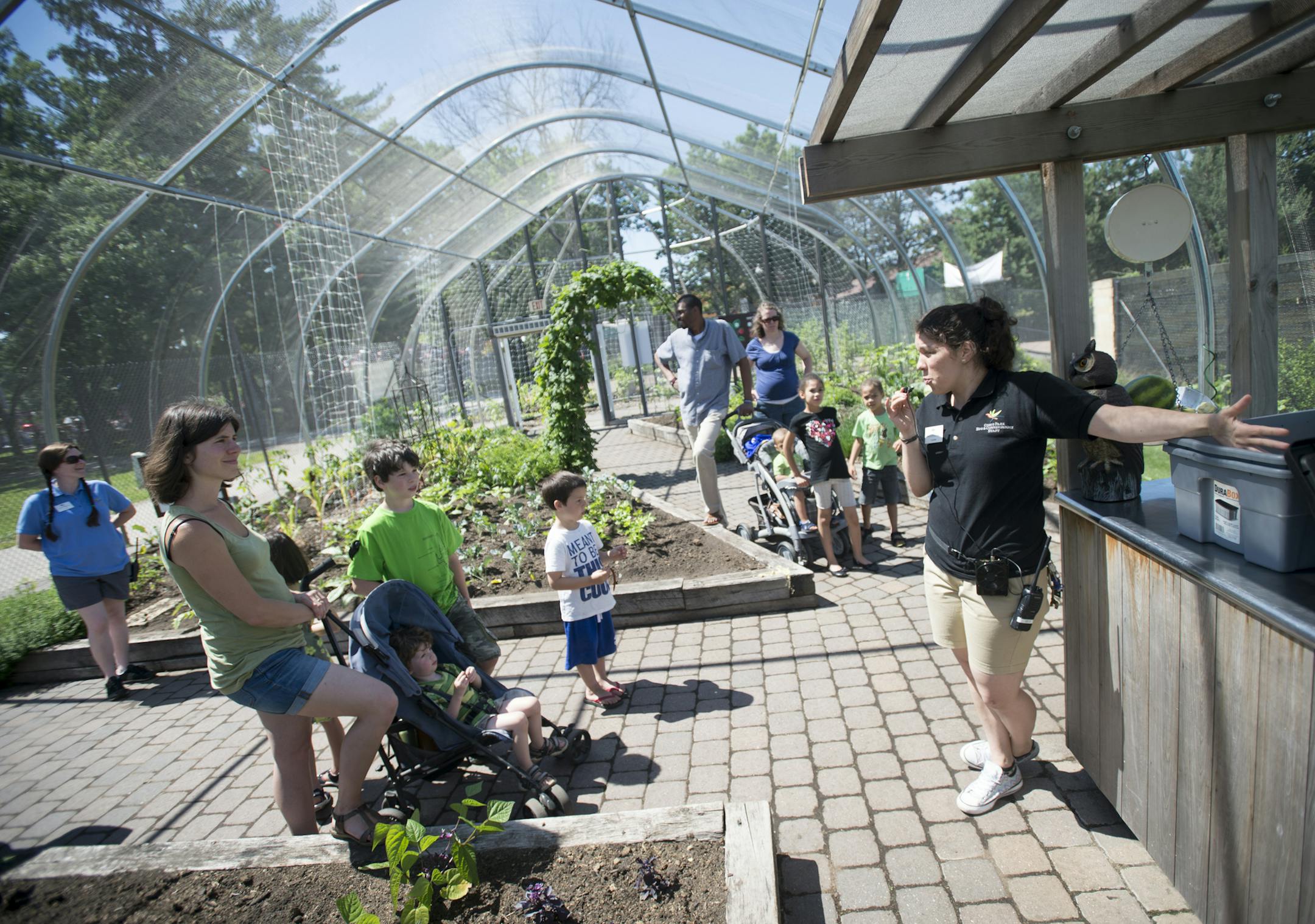 Education specialist Camille Karpik, right, gave a composting demonstration to families visiting Komo Zoo's Edible Garden Friday. ] Aaron Lavinsky • aaron.lavinsky@startribune.com The edible garden at the Como Zoo opened on Friday, June 12, 2015 in St. Paul.