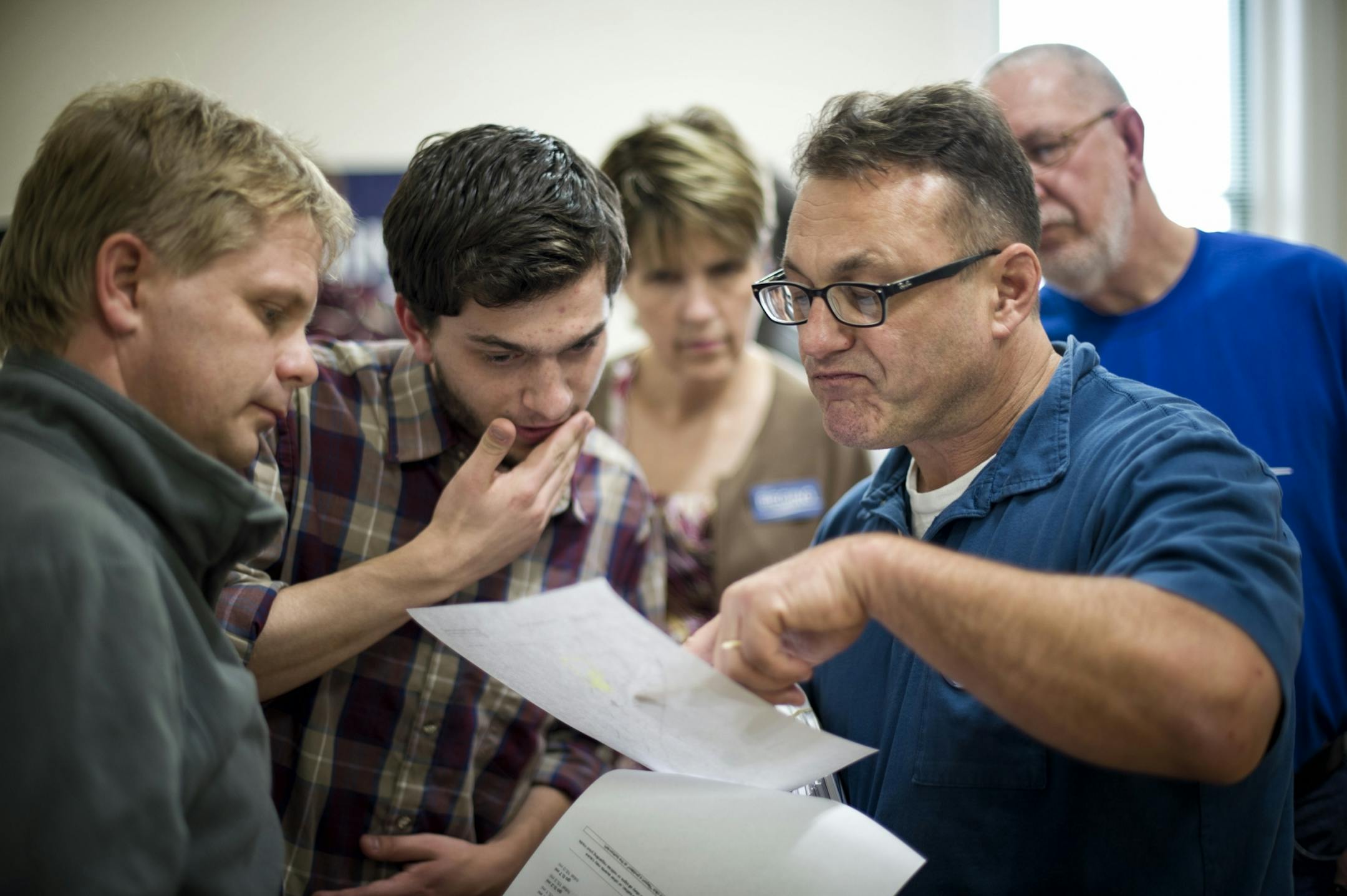 Democratic field organizer Thaddeus McGuire, center, helped volunteers Thorsten Landwehr, left, and Todd Meyers, right, prepare for a literature distribution in a nearby town. Chippewa Falls, WI, is in one of the hotly contested "purple" areas of the state. Wednesday, October 24, 2012