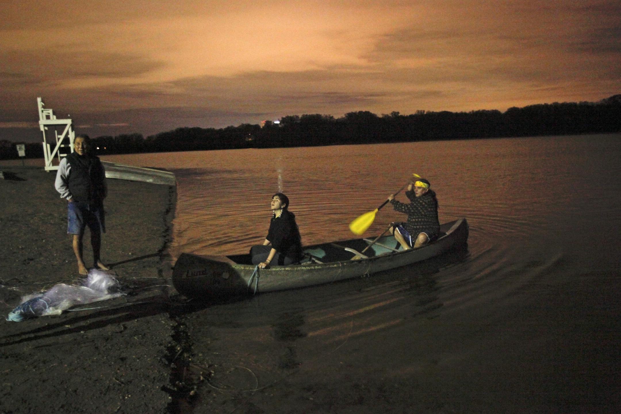 Dakota members Jim Anderson, right to left, Autumn Cavender-Wilson and Chris Mato Nunpa begin to put the net out at about 2 a.m.