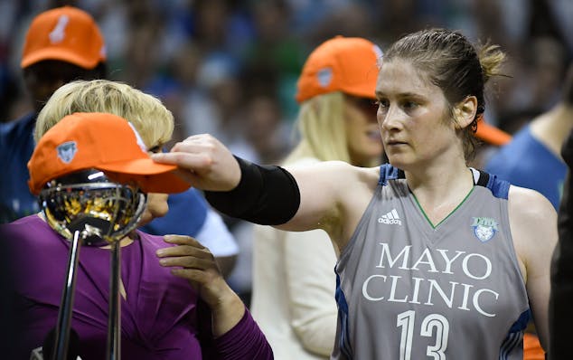 Minnesota Lynx guard Lindsay Whalen (13) puta her championship hat on the WNBA Championship trophy after an 85-76 win against the Los Angeles Sparks i