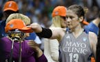 Minnesota Lynx guard Lindsay Whalen (13) puta her championship hat on the WNBA Championship trophy after an 85-76 win against the Los Angeles Sparks i