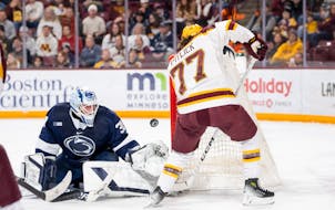 Liam Souliere protects the Penn State net as Gophers forward Rhett Pitlick looks to shoot on Feb. 9 at 3M Arena at Mariucci.