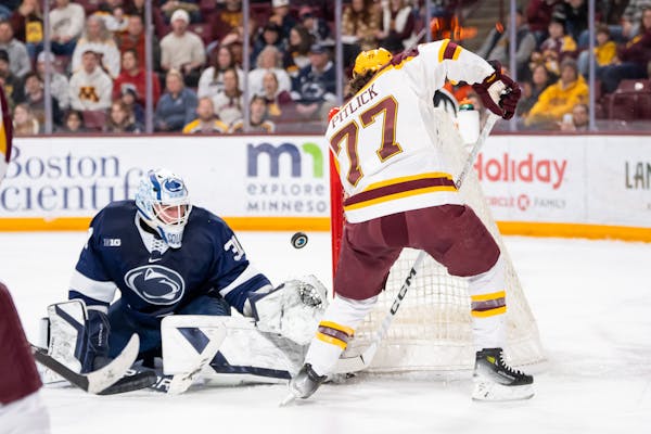 Liam Souliere protects the Penn State net as Gophers forward Rhett Pitlick looks to shoot on Feb. 9 at 3M Arena at Mariucci.