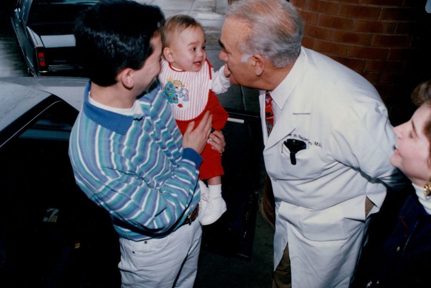 December 22, 1994 1 yr old Davis Fukushima of Atlanta GA is held by his had Dan Fukushima while saying good bye to Dr. John Najarian. Davis received a kidney from his grandmother Roberta Shrewsburryon Dec. 5th.. see attached brief... R. Sennott, Minneapolis Star Tribune