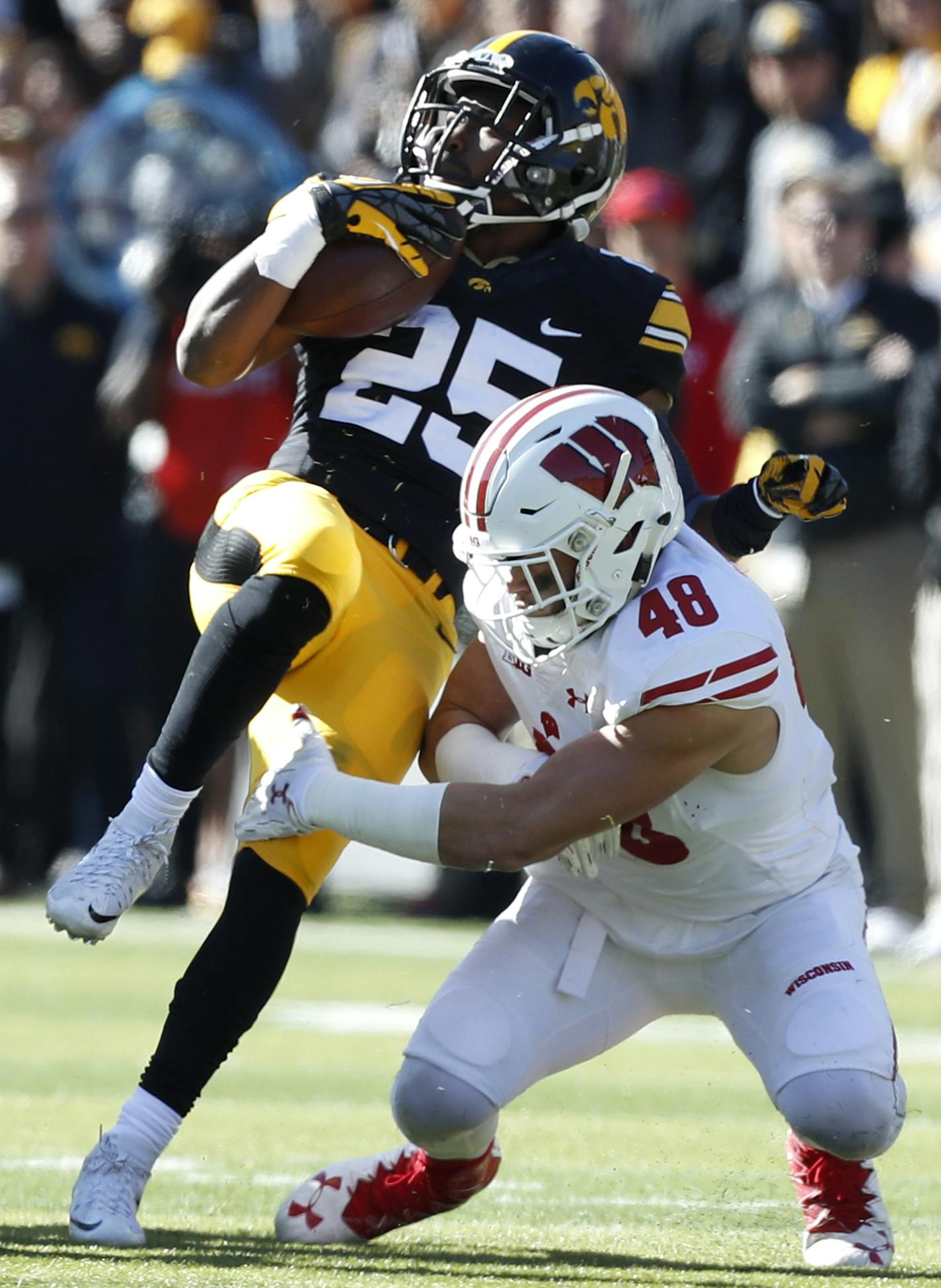 Wisconsin linebacker Jack Cichy (48) tackles Iowa running back Akrum Wadley (25) during the first half of an NCAA college football game, Saturday, Oct. 22, 2016, in Iowa City, Iowa. Wisconsin won 17-9. (AP Photo/Charlie Neibergall)