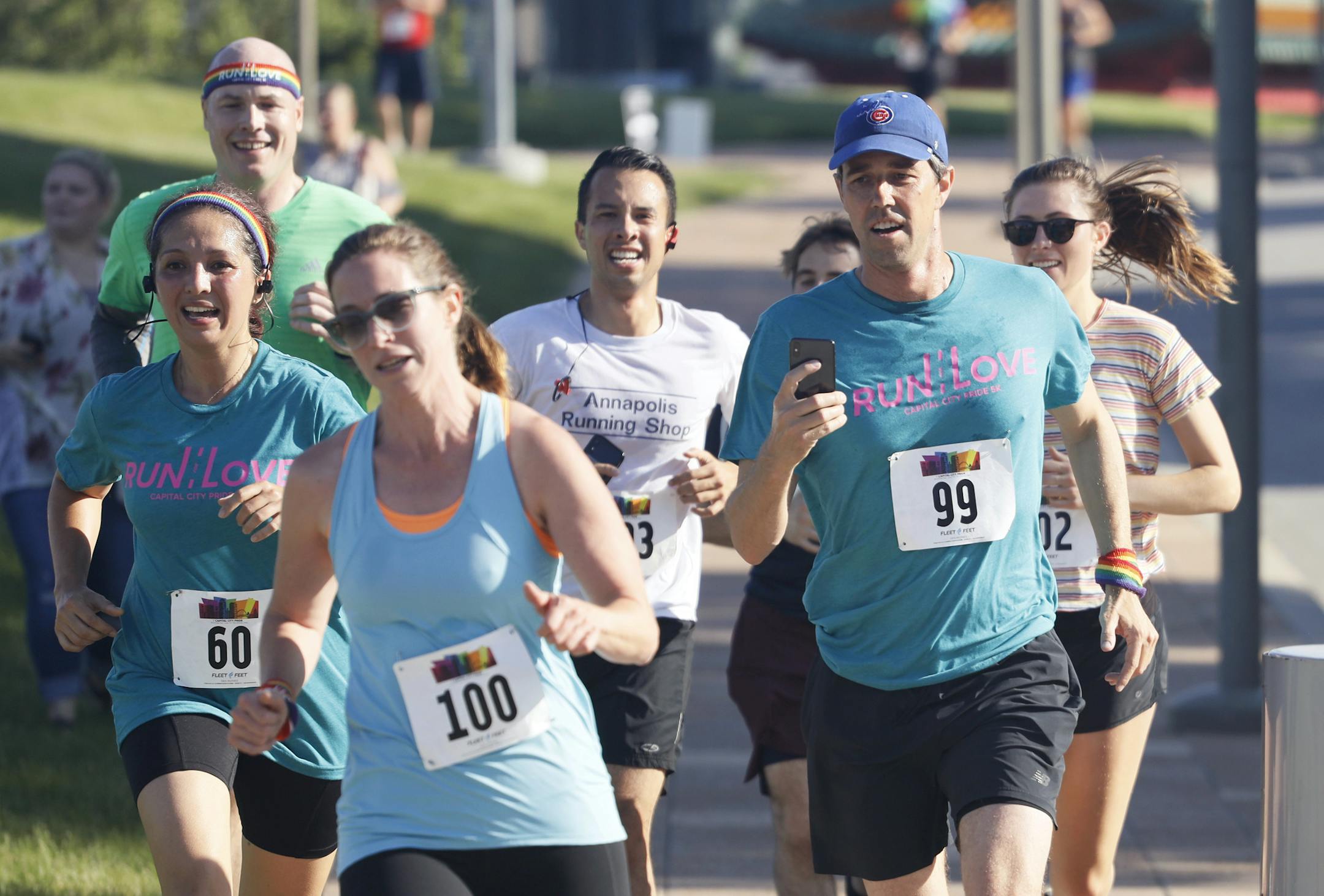 Democratic presidential candidate Beto O'Rourke, right, runs the Capital City Pride Fest Fun Run 5K with his wife Amy, left, Saturday, June 8, 2019, in Des Moines, Iowa. (AP Photo/Charlie Neibergall)