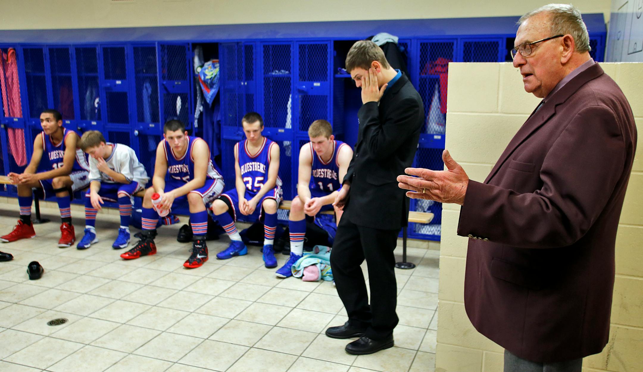 Coach Bob McDonald talked to his players in the locker room during halftime of a game against Northeast Range.