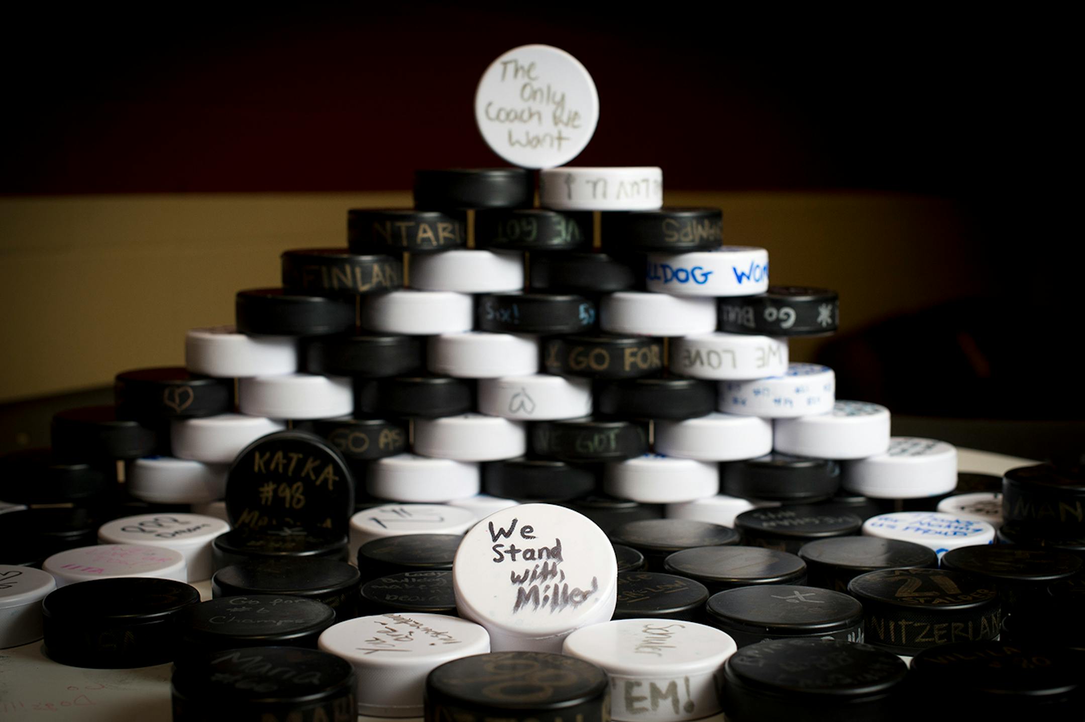 Hollow rubber hockey pucks, signed with messages of support for head coach Shannon Miller by fans, are on display in the players' lounge in Amsoil Arena. ] (Aaron Lavinsky | StarTribune) University of Minnesota Duluth told women's hockey head coach Shannon Miller that this season would be the las of her successful run as the Bulldog's coach. After five national championships, an NCAA record, and 11 Frozen Four Victories, Miller, the highest-paid coach in women's hockey, was told her contract wou
