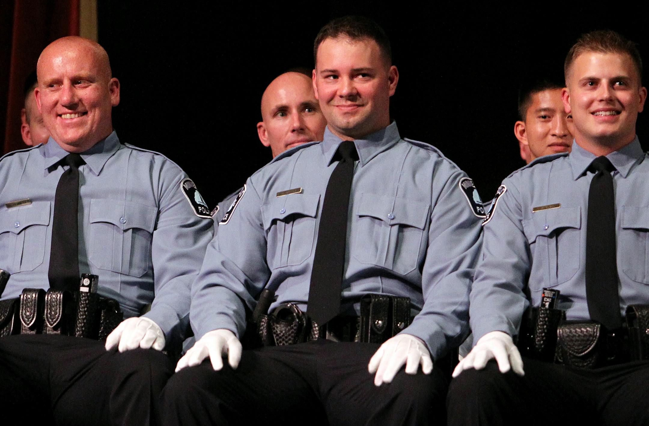 Recruits crack a smile during the summer 2013 recruit class police officer graduation ceremony at DeLaSalle High School in Minneapolis, Minn., on Tuesday, July 30, 2013. ] (ANNA REED/STAR TRIBUNE) anna.reed@startribune.com (cq)