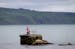 A pink statue of a man fishing next to his bike sits on the rocks at Waterfoot, Northern Ireland, Tuesday, May, 6, 2014, in preparation for the Giro d