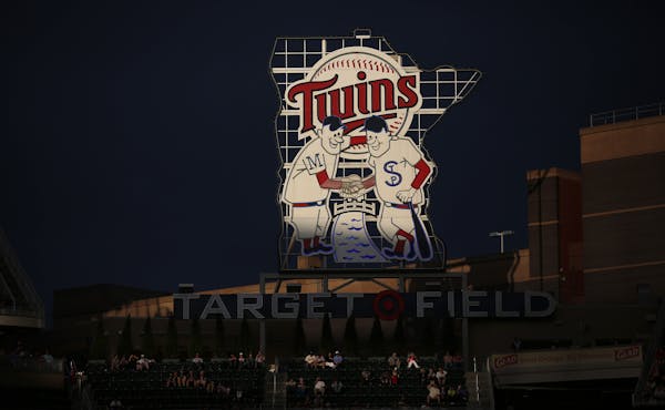 A beam of light illuminated the Twins sign in centerfield in the third inning of Tuesday night's game between the Minnesota Twins and Texas Rangers at