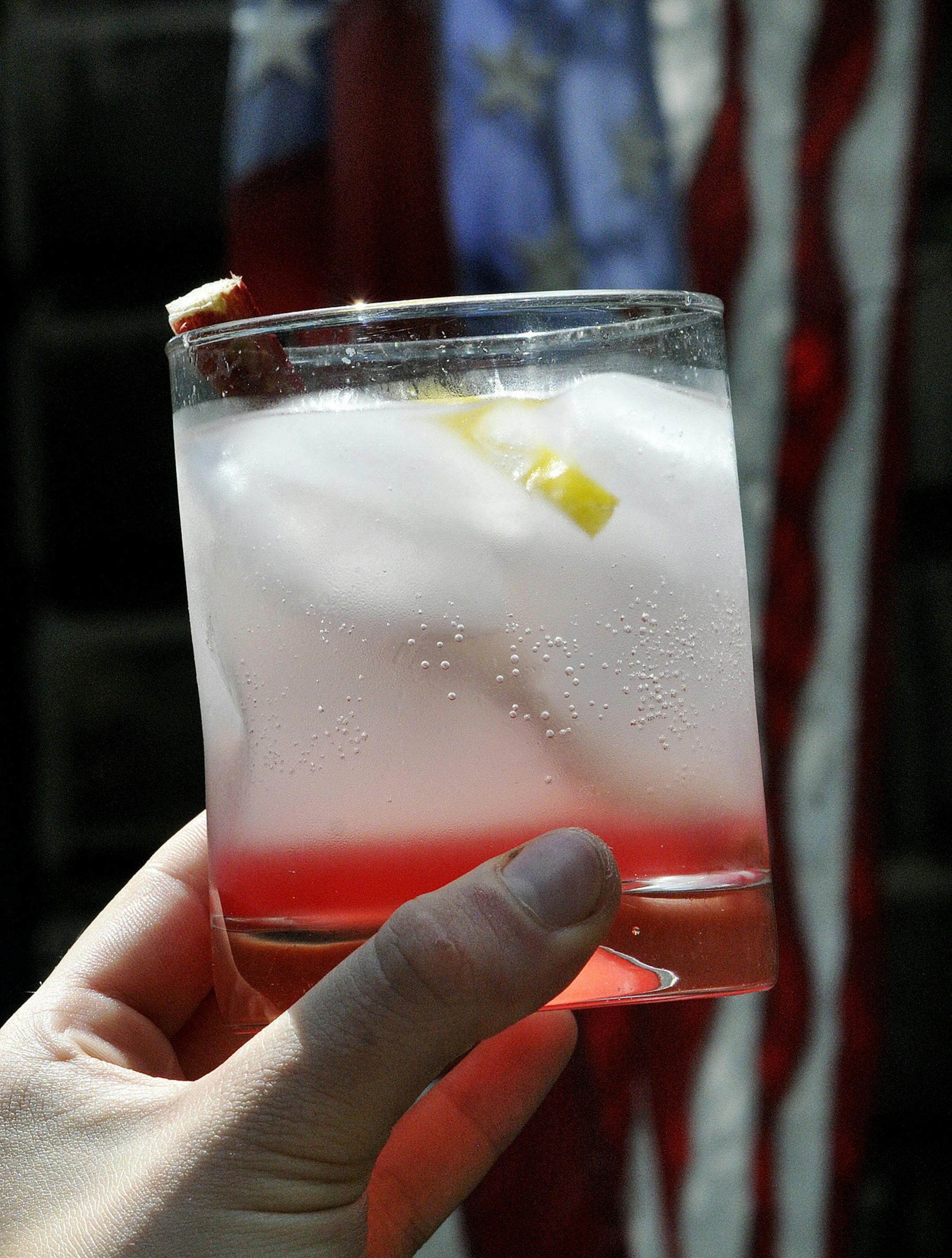 Rhubarb syrup with club soda, vodka, rhubarb stirrer and lemon twist.